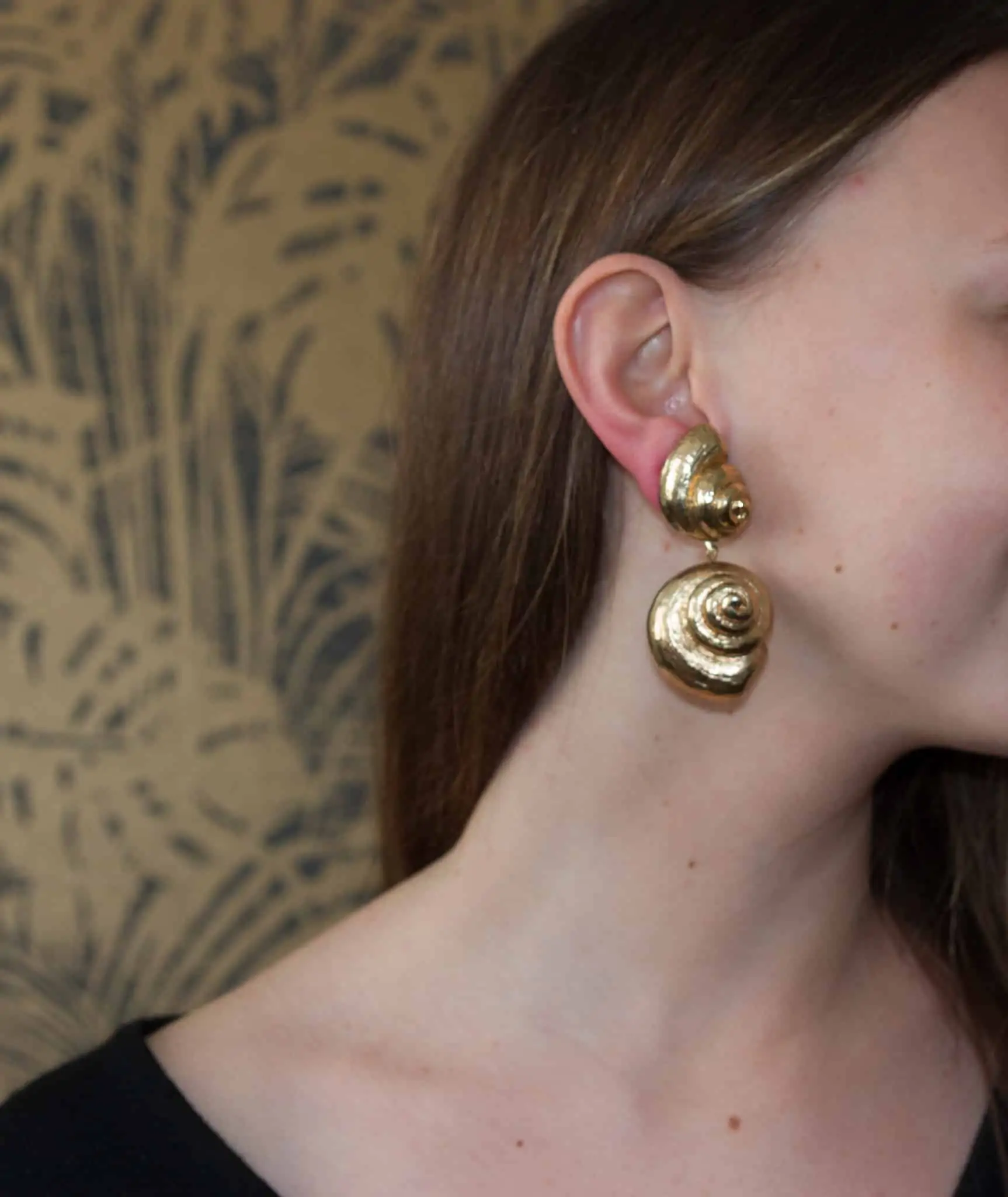 gold chanel earrings on ear